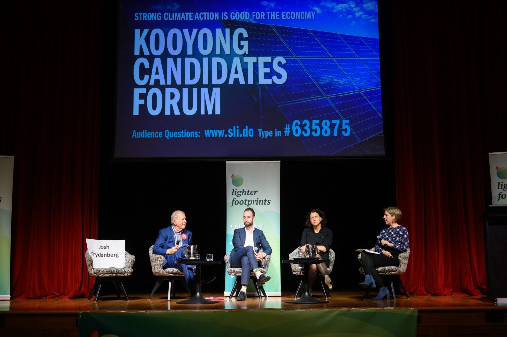 The three candidates on stage with the moderator
