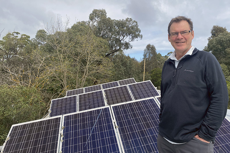 Mick Nolan with rooftop solar panels in East Kew