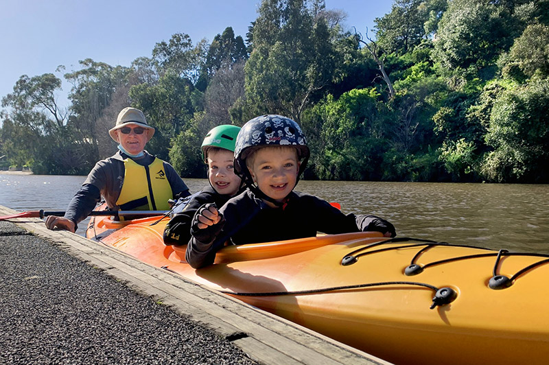 Ray Peck kayaking with his grandchildren on the Yarra River in Hawthorn