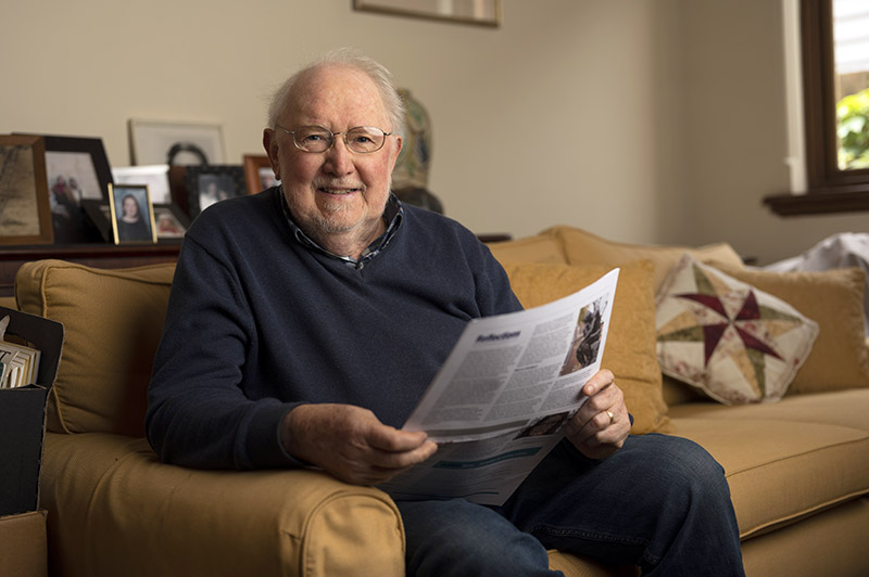 Bill Chandler reading the Eastsider News at home in Surry Hills